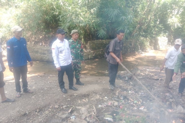 Dukung Program Bersih- Bersih Babinsa Desa Buanajaya Turut Bersihkan Bantaran Sungai Cimapag
